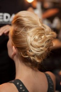 A woman with a messy hair bun.